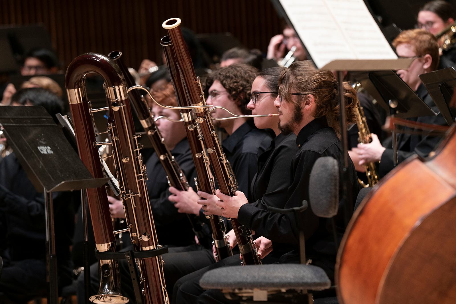 Members of the UMD Wind Ensemble play instruments during a performance.