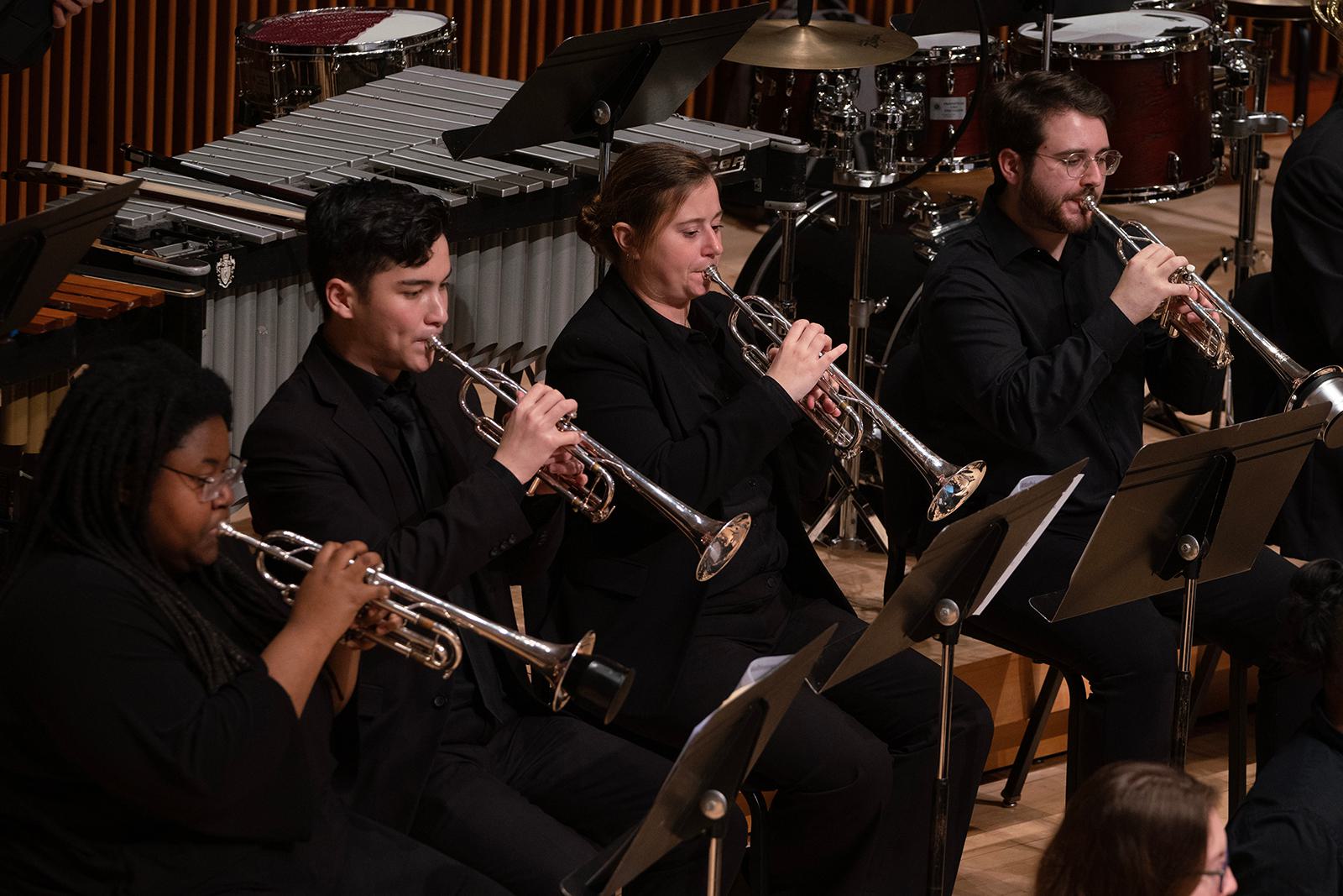 Members of the UMD Wind Orchestra Perform on stage.