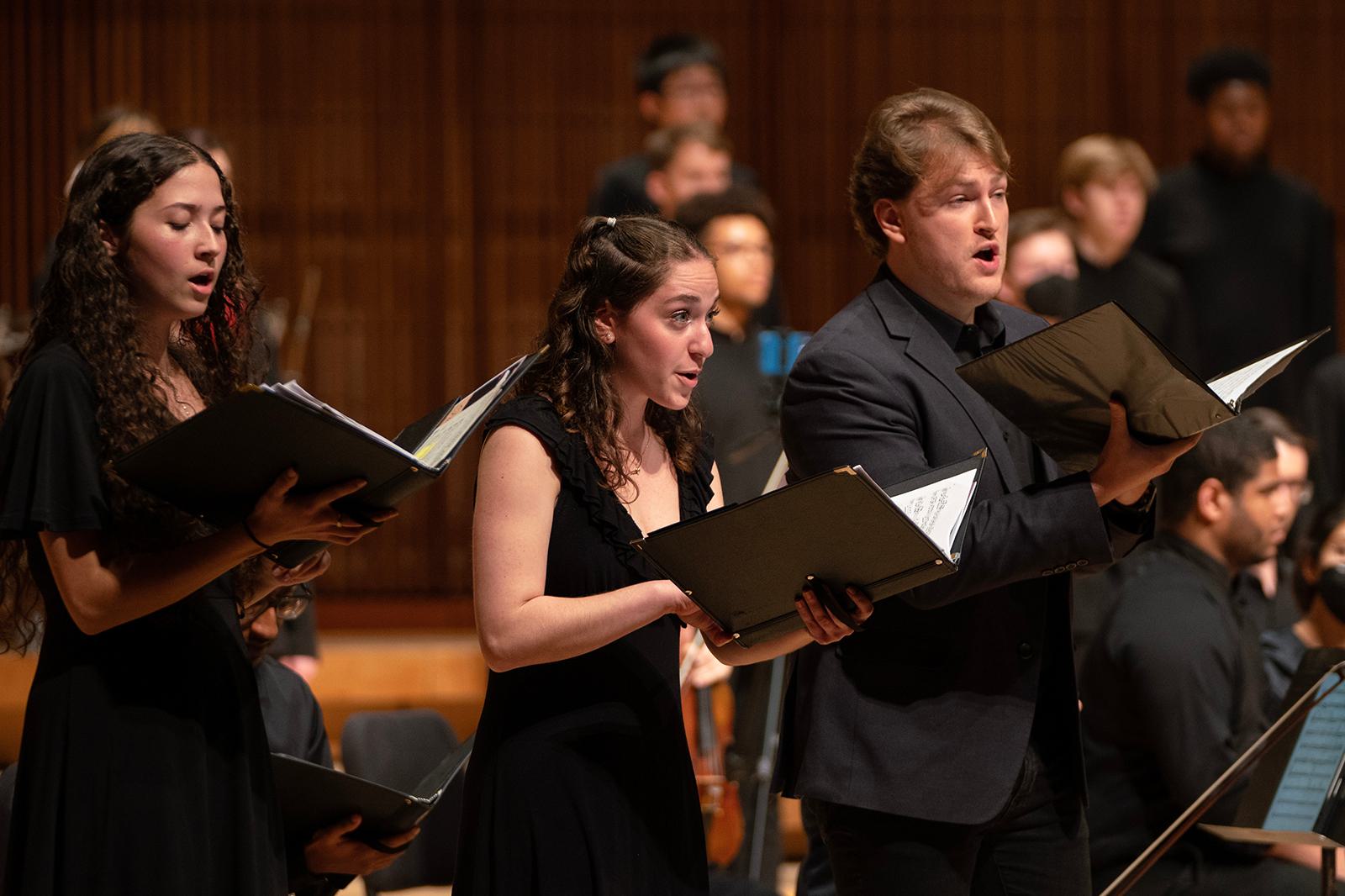 Members of a choir sing.