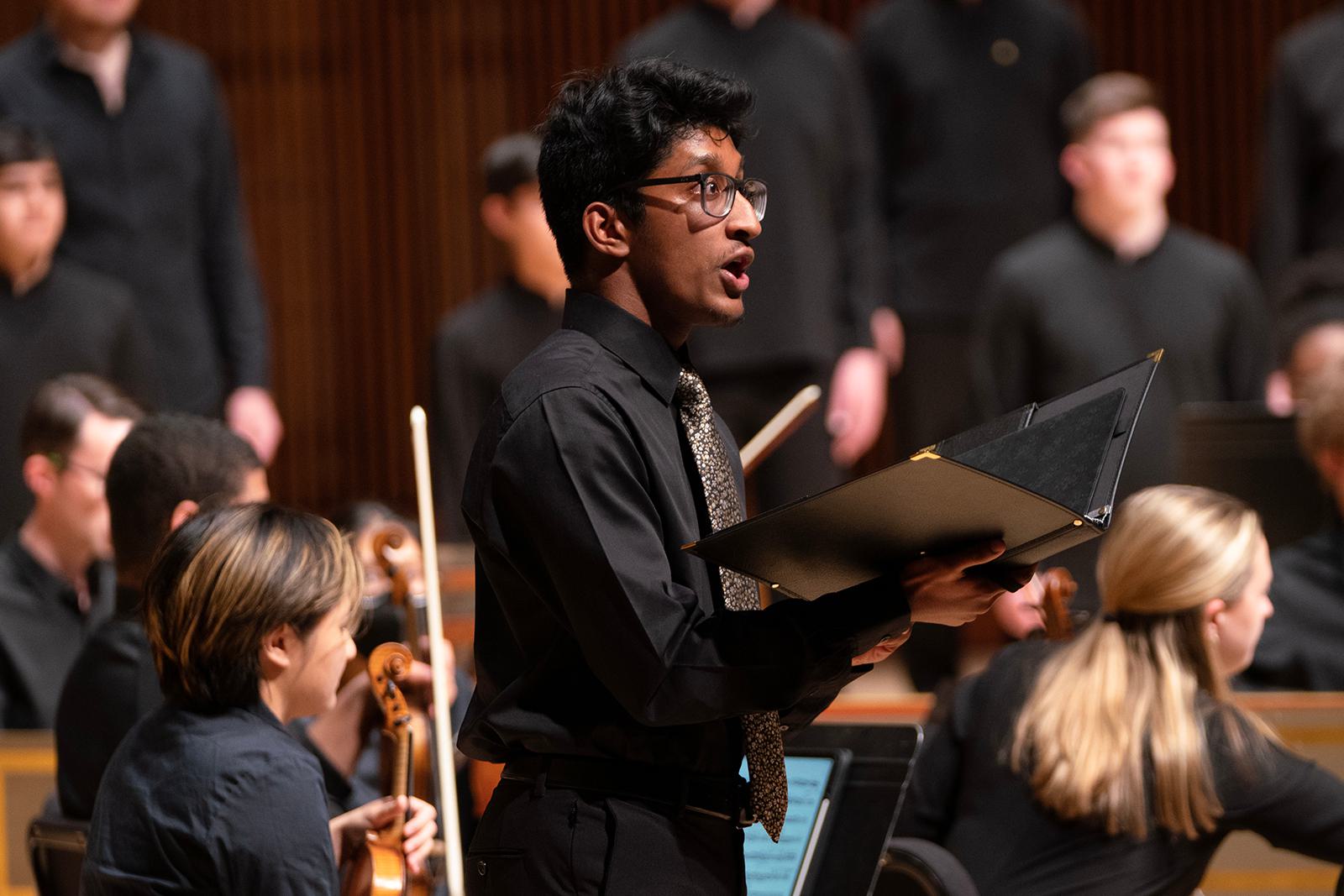 A choral student sings during a concert.