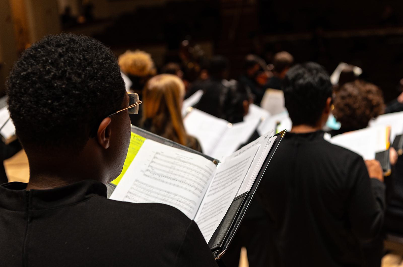 Choral group members performing.