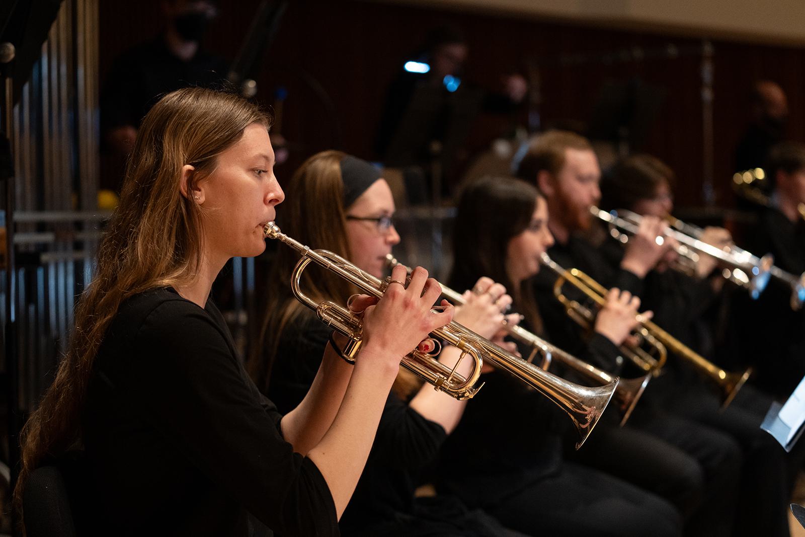 Members of the UMD Wind Orchestra play trumpets.