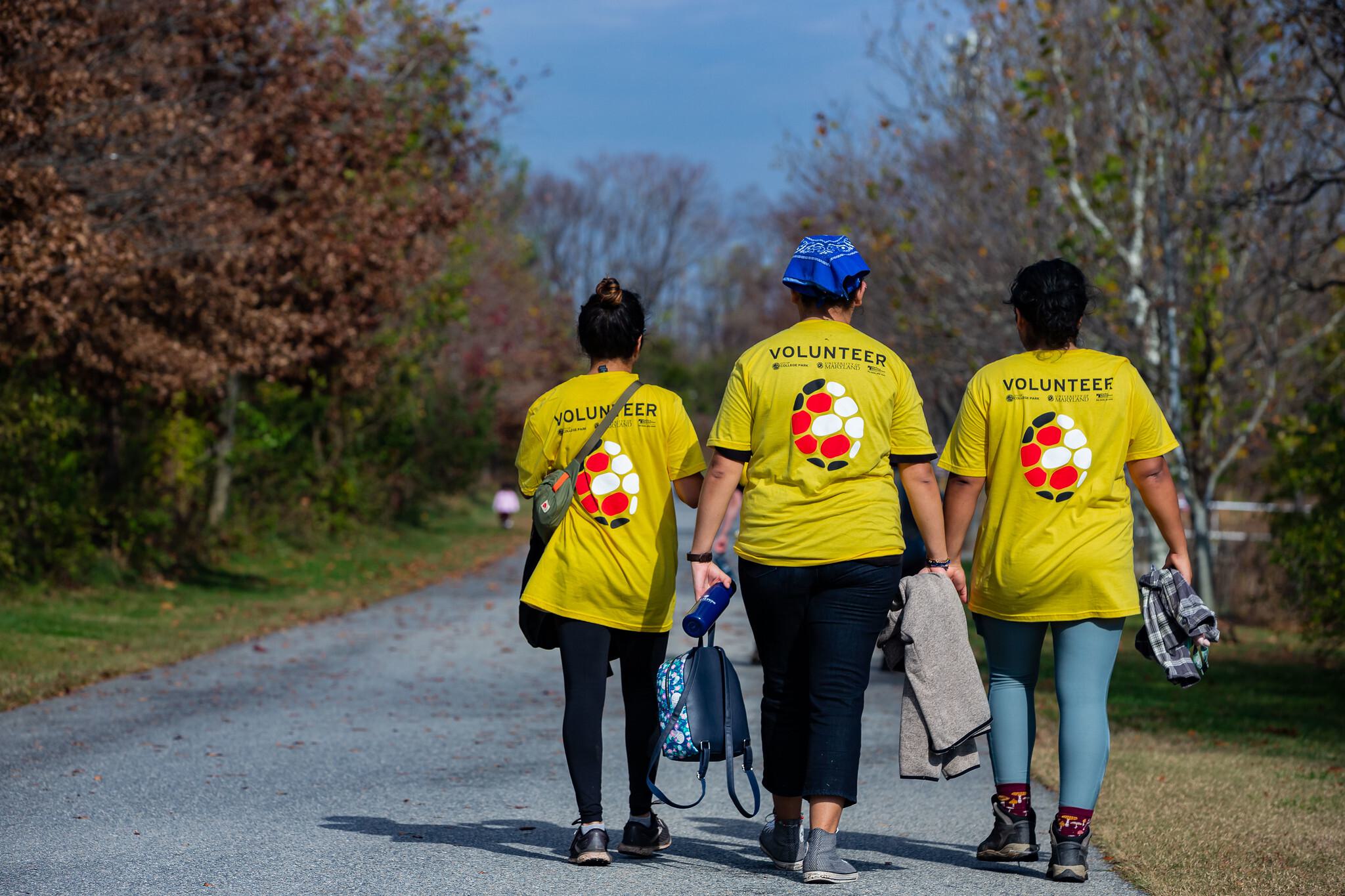 Three volunteers walking around Lake Artemesia