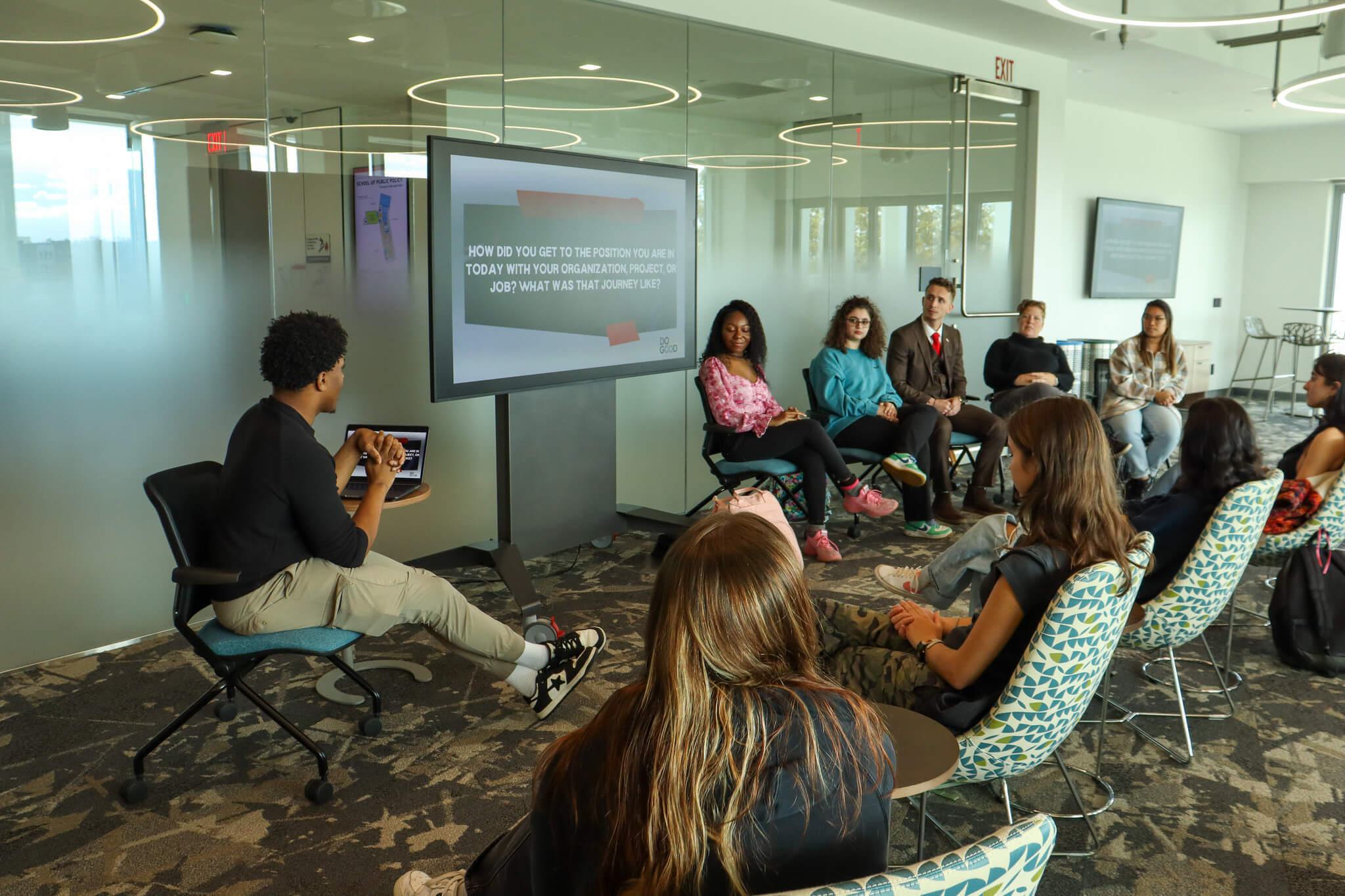 People sitting in chairs in a semi circle