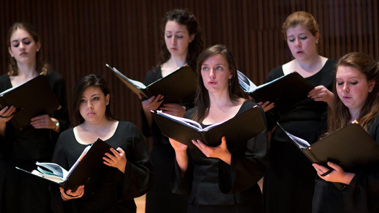 Choral students perform on stage.