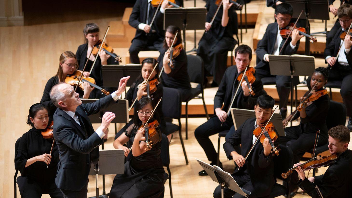 Orchestral students performing on stage.