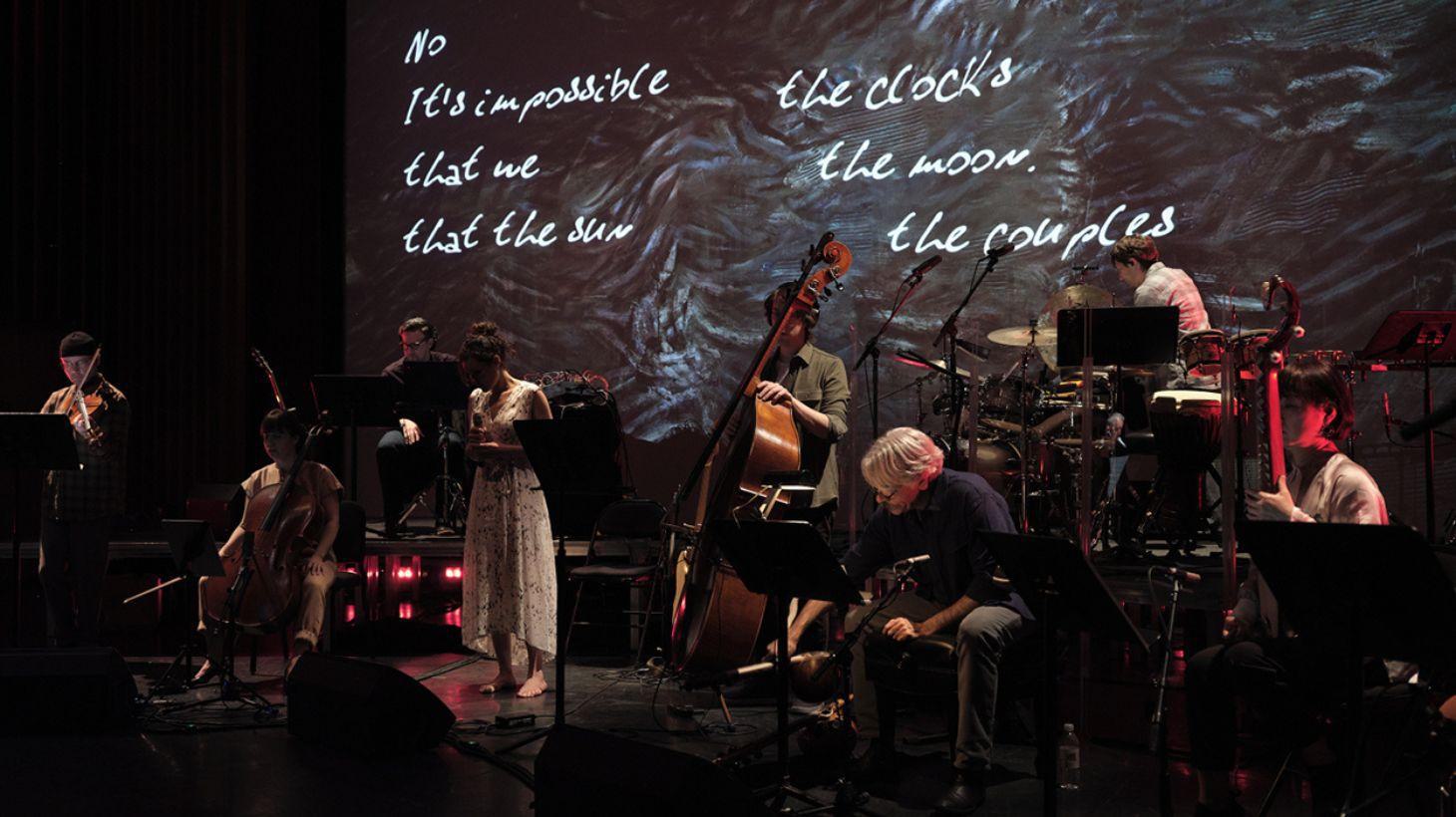 Musicians perform on stage.