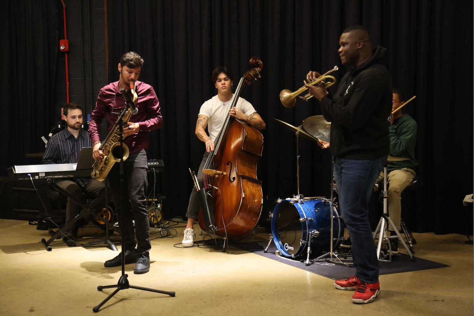 Members of a band play various instruments during a performance.