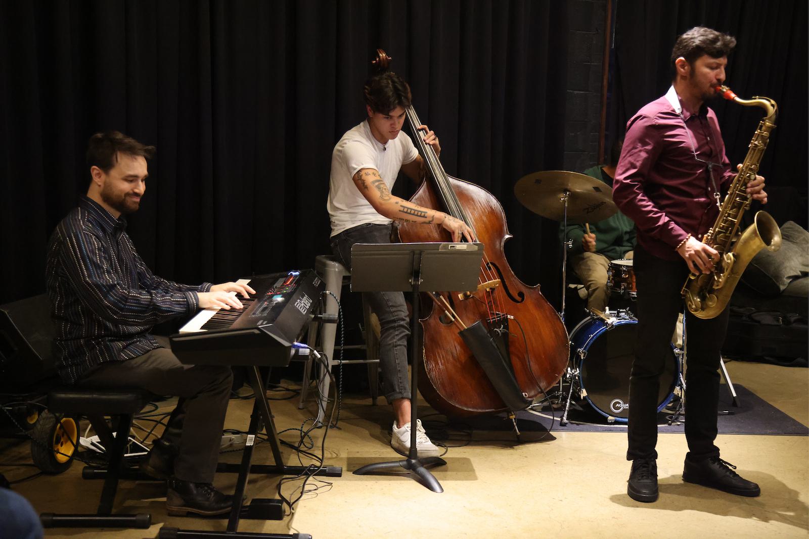 Three students play instruments at The Hall CP.