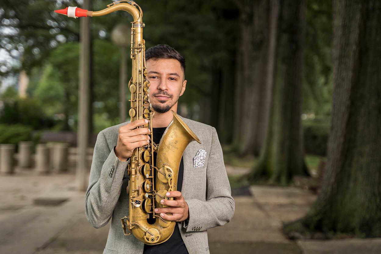 Elijah Jamal Balbed poses with a saxophone.
