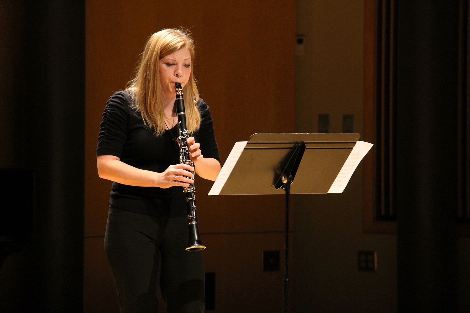 A music student plays a clarinet during a performance.