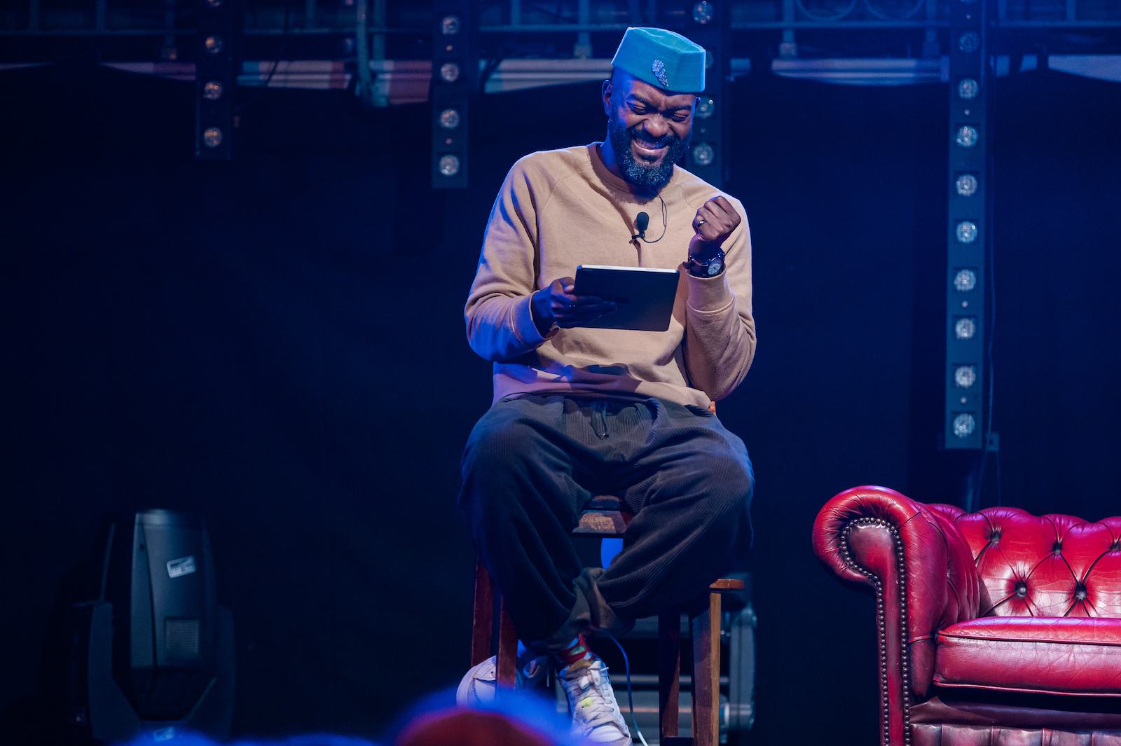 Inua Ellams performing on stage.