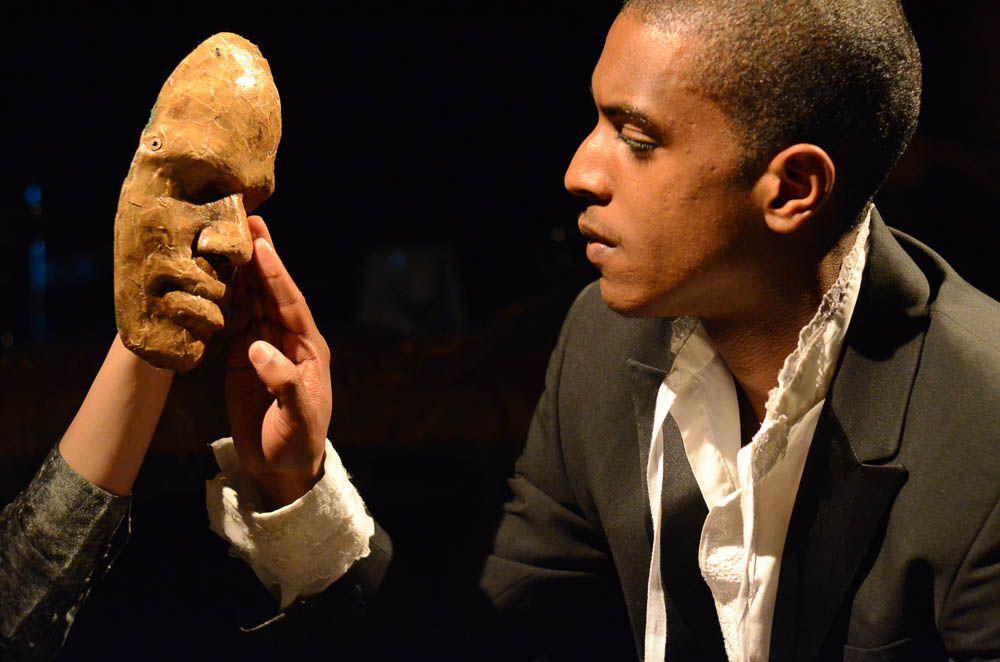 A man touches a face mask.
