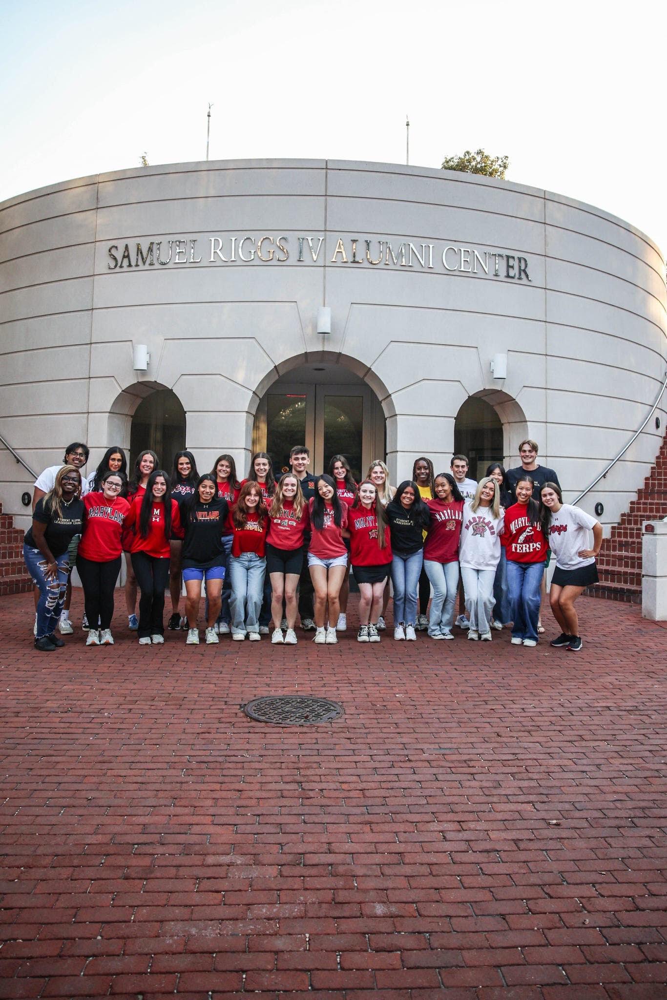 SALC members posing and smiling in front of Samuel Riggs IV Alumni Center
