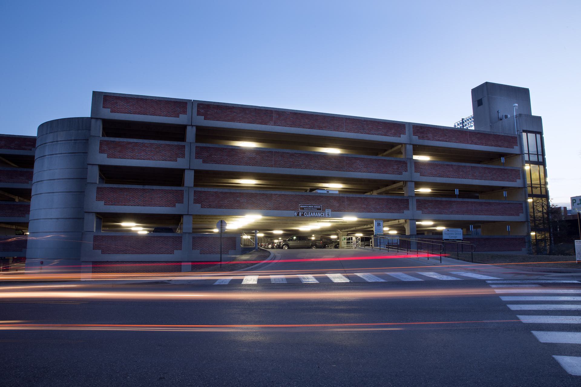 An on-campus parking garage at dusk.