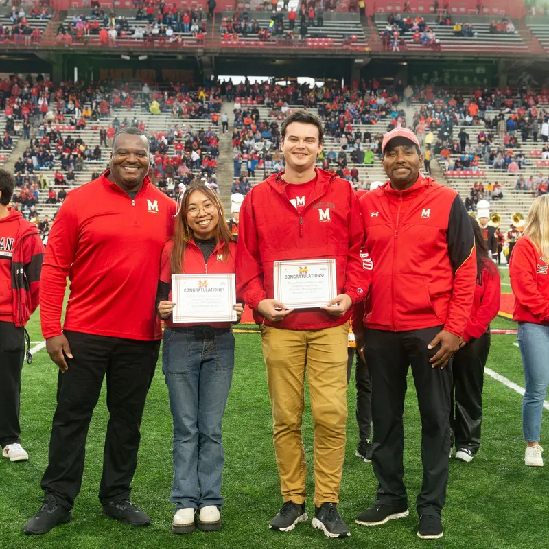 The winners of the 2024 Spirit of Maryland Award accept the honor during halftime.