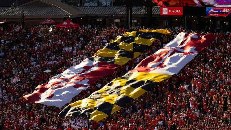 The Maryland state flag cascades down over the student section at SECU Stadium.