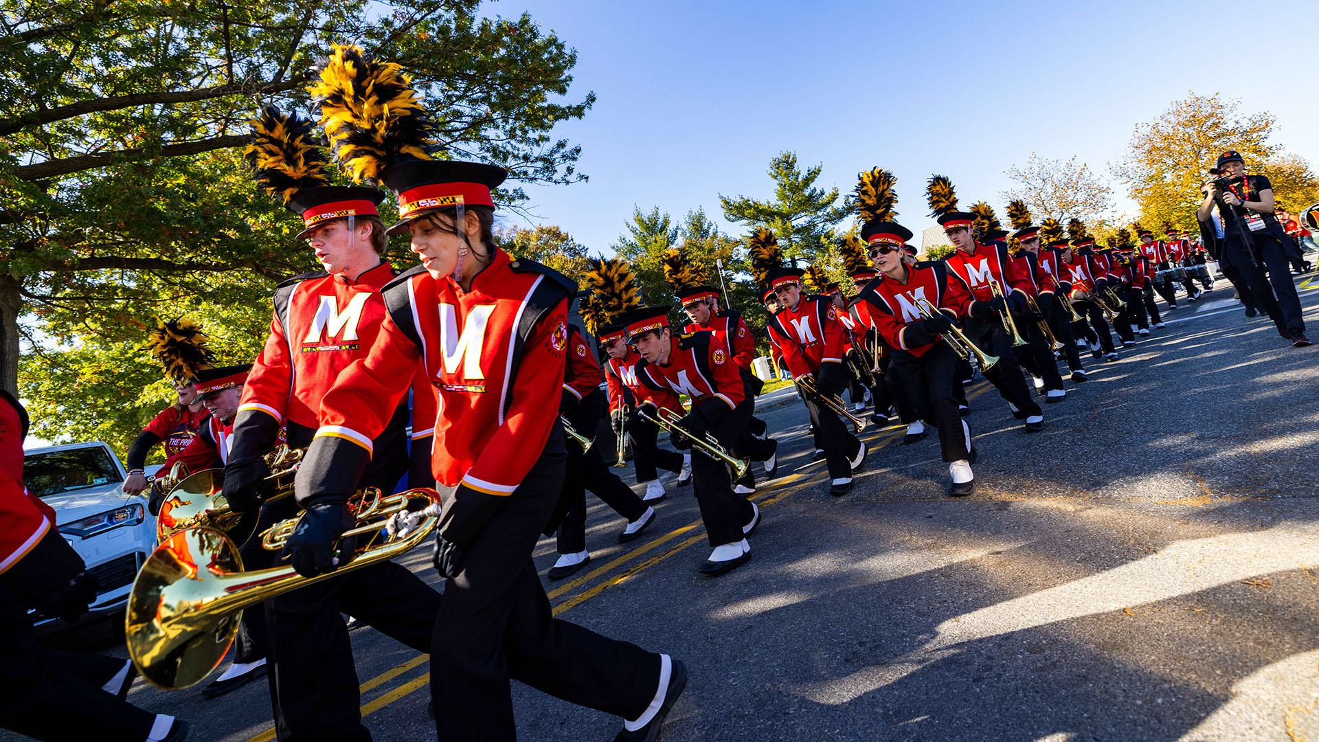 The Mighty Sound of Maryland marching band makes it way through Terp Walk, a gameday tradition that welcomes the football team to campus.