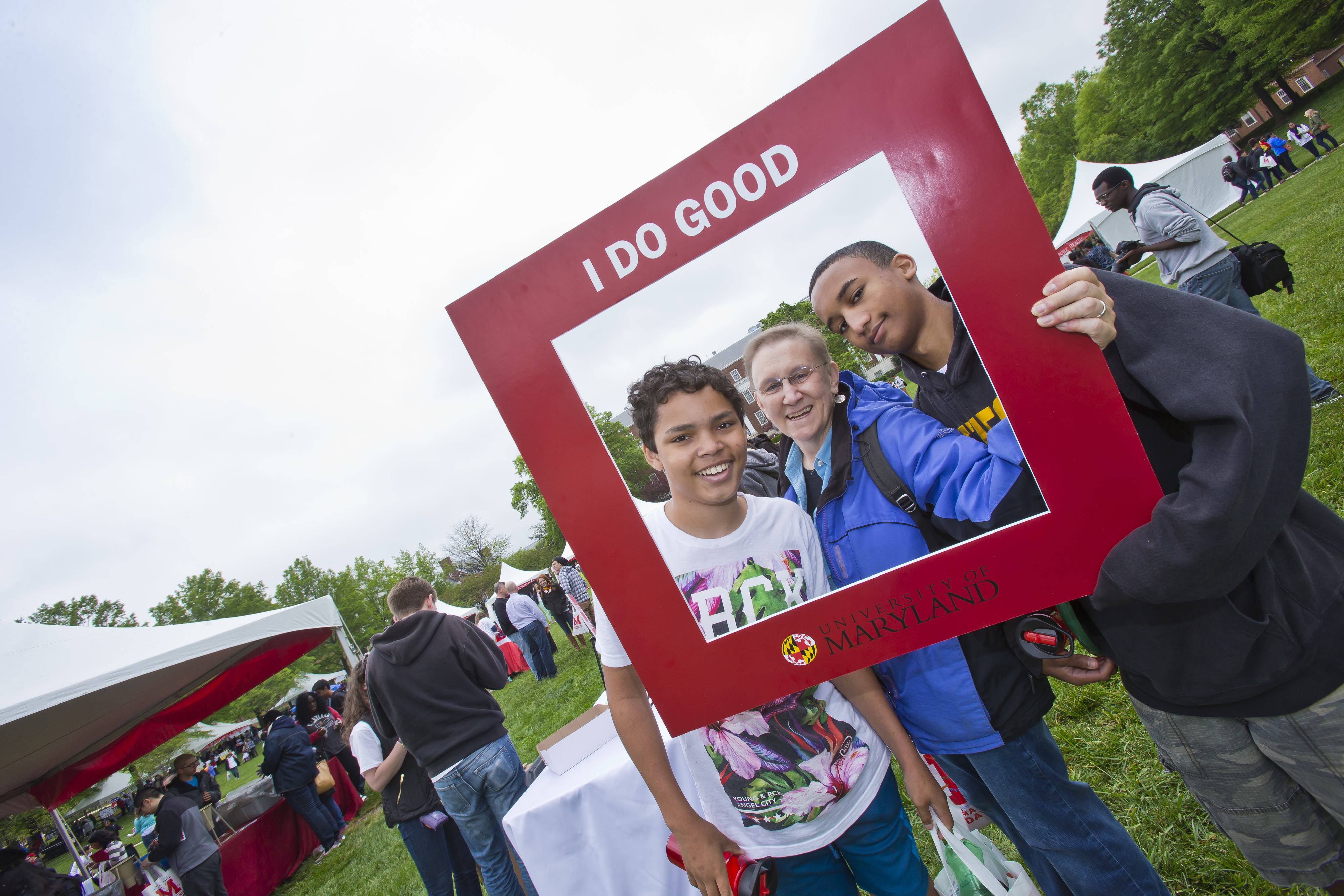 Students pose with "I Do Good" frame